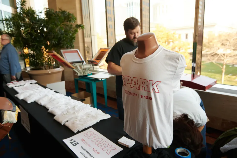 SPARK T-shirt on a mannequin at the merch table